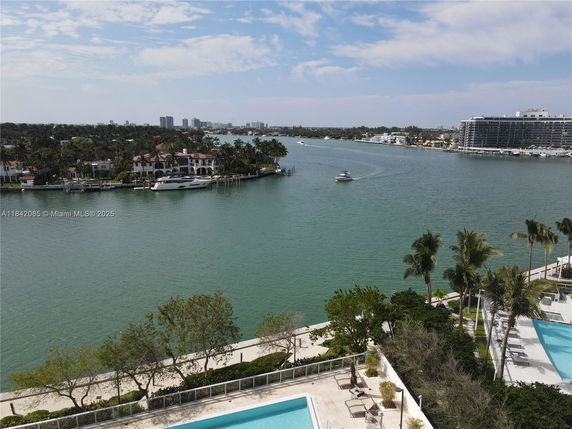 Wide angle view of a waterfront area with luxury homes and boats.