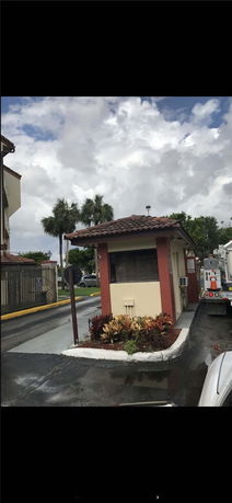 Front view of a small security booth with a tiled roof.