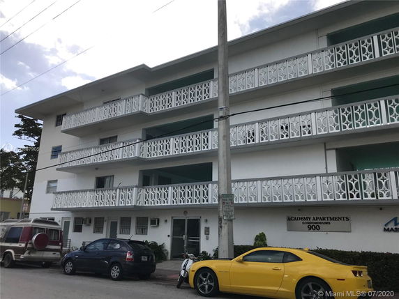 Front view of a multi-story apartment building with decorative railings.