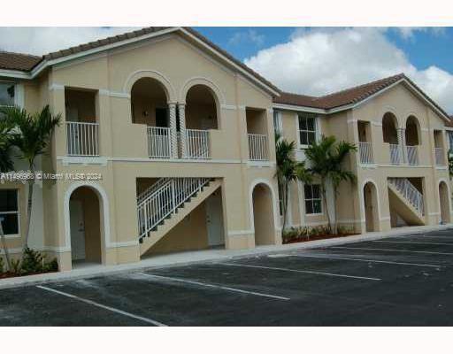 Front view of a two-story building with arches and multiple staircases.