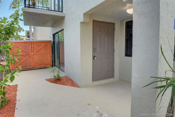 Entrance view of a house with a front door and a wooden gate.
