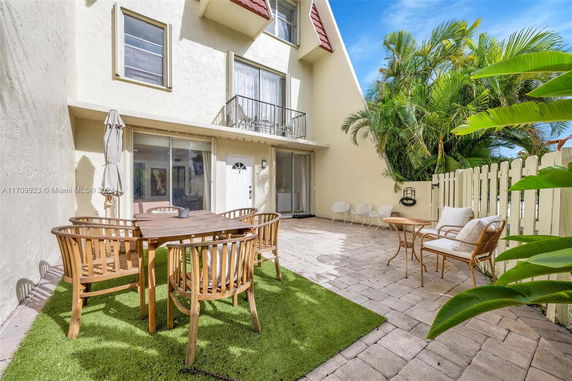 Outdoor patio area with seating and view of a building exterior.