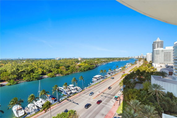 Wide angle view of a river, road, and buildings from a high vantage point.