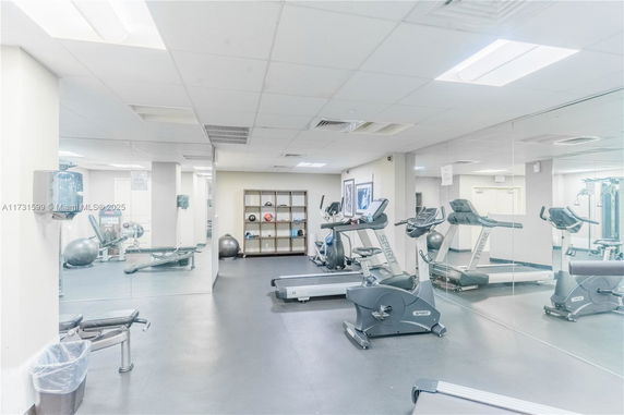 Interior view of a gym with exercise equipment such as bikes and treadmills.