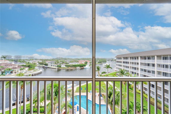 Panoramic view of waterfront area with multi-story buildings and a swimming pool.