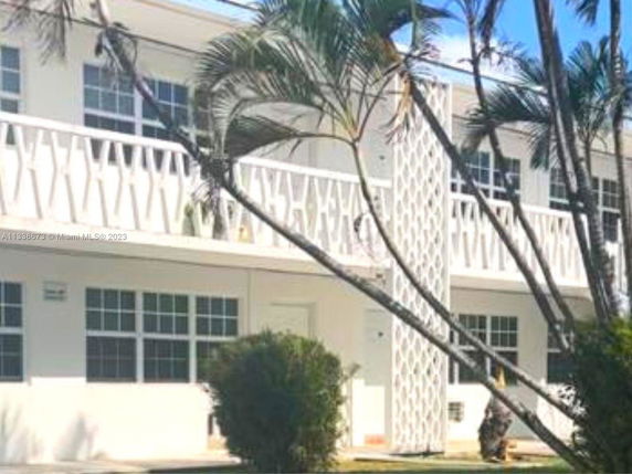 Front view of a two-story building with a decorative balcony.
