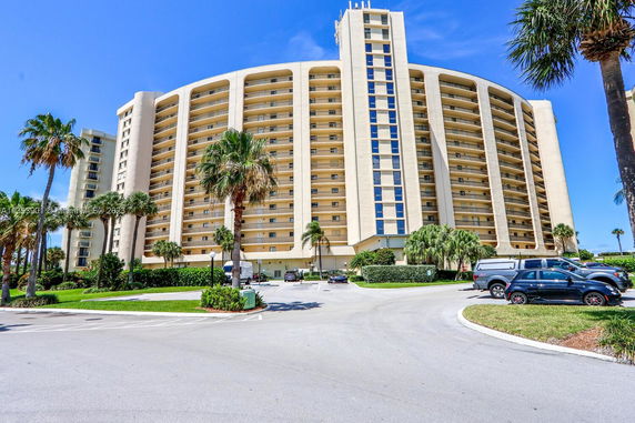 Front view of a large multi-story residential building with balconies.