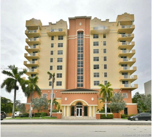 Front view of a multi-story residential building with balconies.