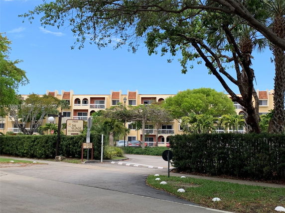 Front view of a multi-story residential building with balconies.