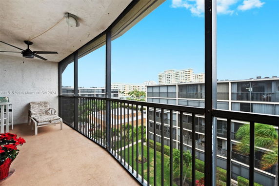 Balcony view overlooking surrounding residential buildings and greenery.