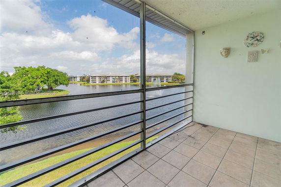 View from a balcony overlooking a lake and surrounding buildings.