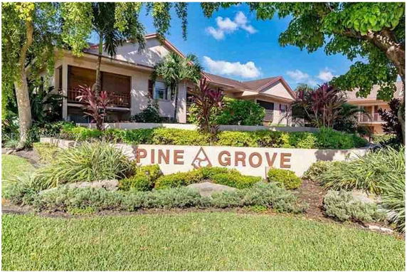 Front view of a house with a large sign reading Pine Grove.