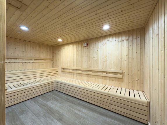 Interior view of a wooden sauna room with bench seating.