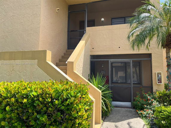 Front view of a two-story building with staircase access.