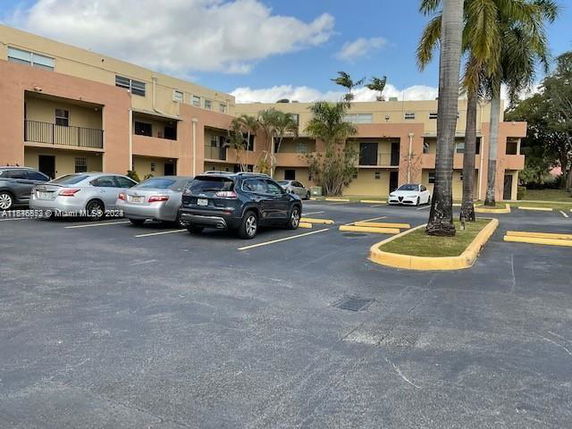 Outdoor parking area in front of a multi-story building.