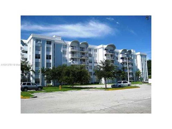 Front view of a multi-story apartment building with balconies.