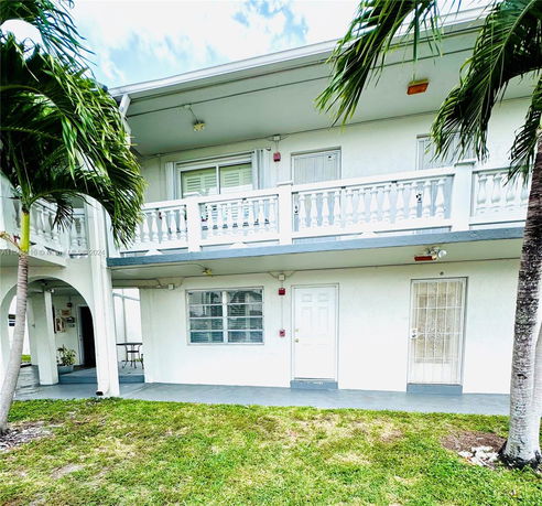 Front view of a two-story building with balconies.