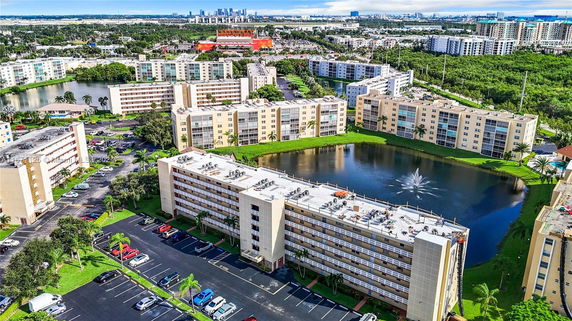Panoramic view of multiple residential buildings with a pond in the center.