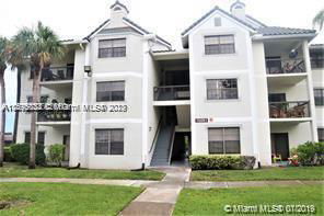 Front view of a multi-story apartment building with multiple balconies.