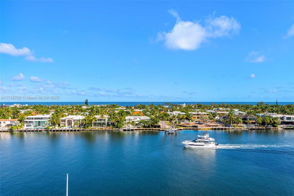Panoramic view of waterway with boats and waterfront homes.