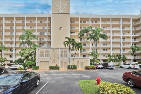Front view of a multi-story apartment building with balconies.