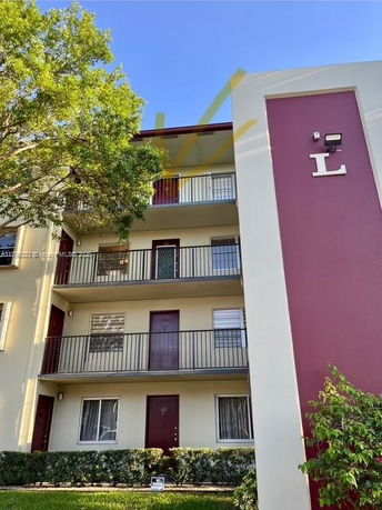Front view of a multi-story apartment building with balconies.
