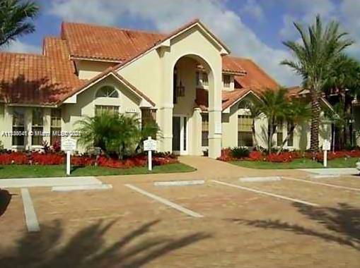 Front view of a house with a tiled roof and archway entrance.