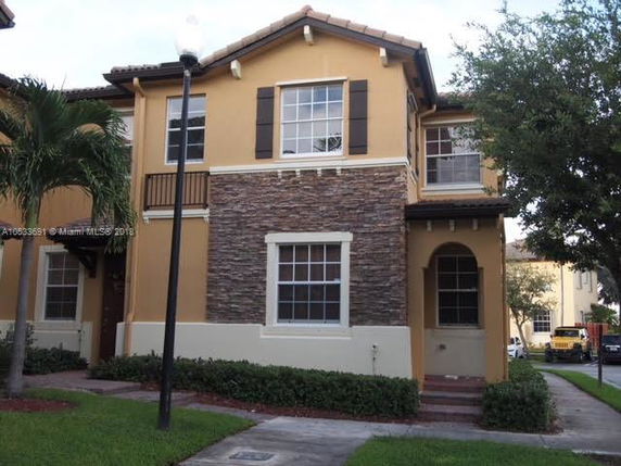 Front view of a two-story house with stone accents and a covered entryway.