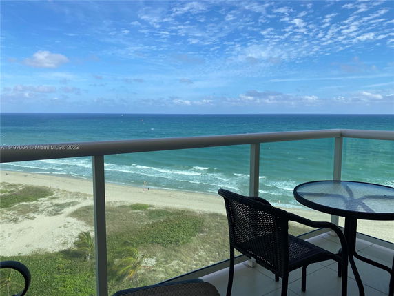 Panoramic view from a balcony overlooking the ocean.