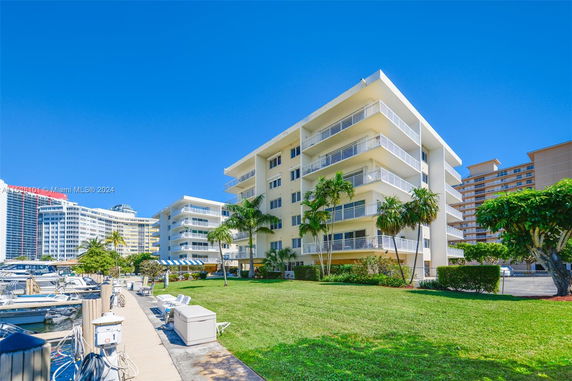 Front view of a mid-rise apartment building with balconies.