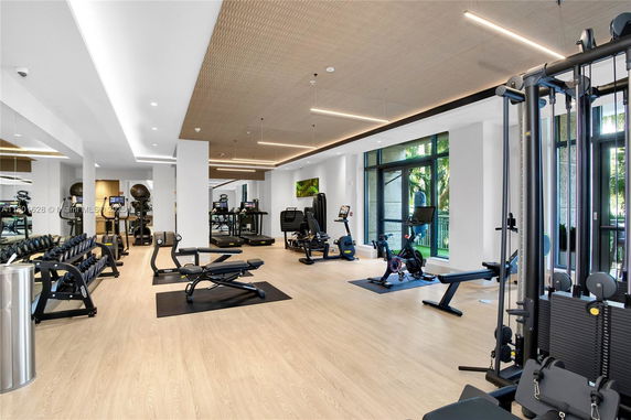 Indoor gym facility with exercise equipment and mirrors.