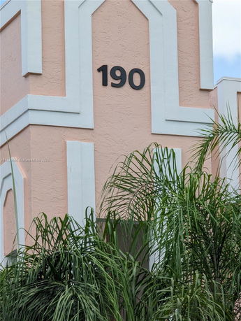 Close-up view of a building facade with the number 190 displayed.