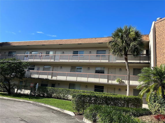 Front view of a three-story residential building with balconies.