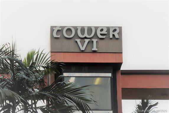Front view of a building labeled 'Tower VI' with visible windows.