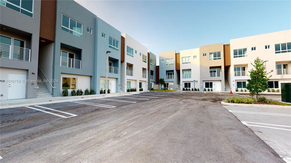 Front view of modern multi-story apartment buildings with balconies.