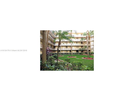 Front view of a multi-story residential building with balconies.