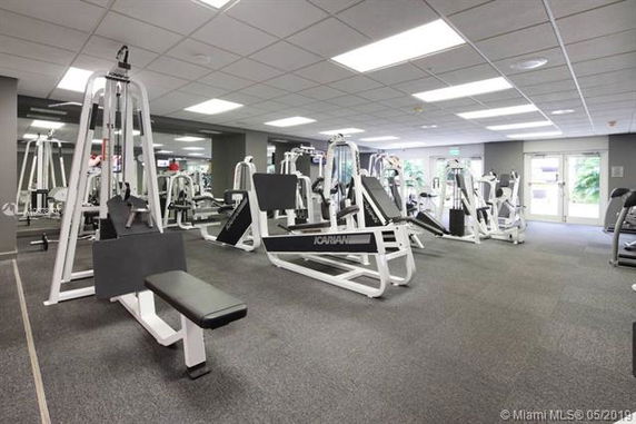 Interior view of a gym with various exercise machines and equipment.