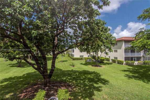 View of buildings surrounded by trees and grass.
