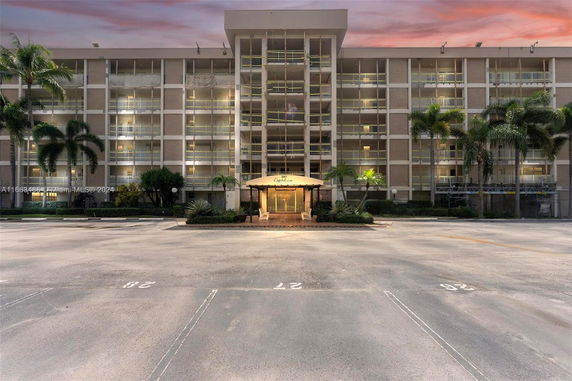 Front view of a multi-story apartment building with balconies.