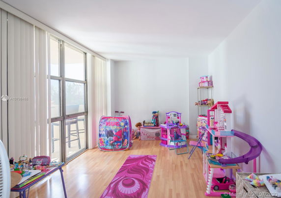 Indoor play area with various toys and play equipment.