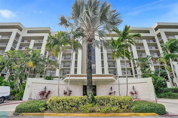 Front view of a multi-story residential building with balconies.