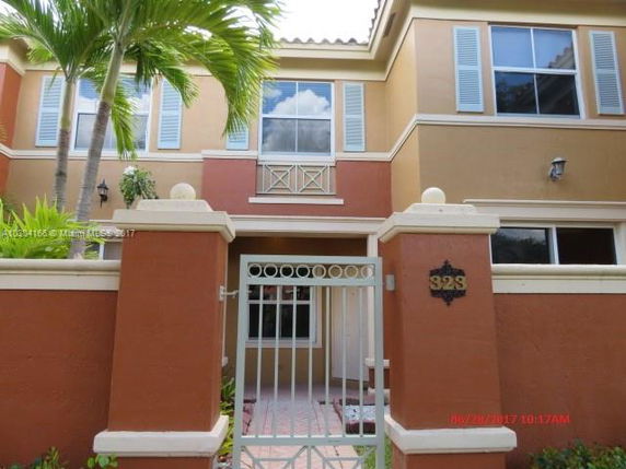 Front view of a two-story house with a gated entrance.