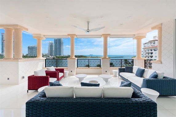 Covered outdoor seating area with views of city skyline and ocean.