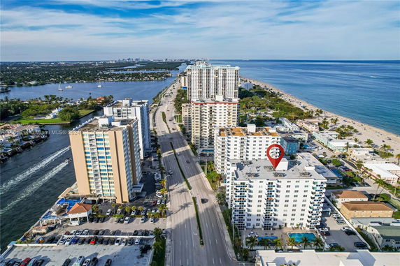 Panoramic view of coastal cityscape with tall buildings and ocean.