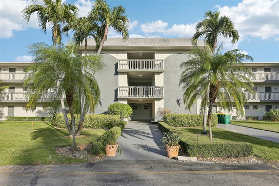 Front view of a multi-story residential building with balconies.