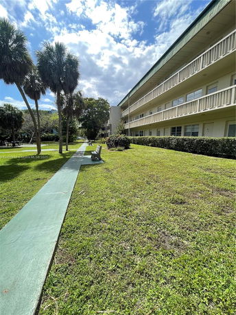 Front view of a multi-story building with balconies.