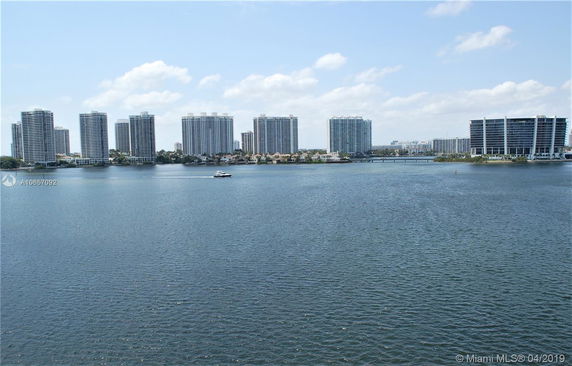 View of multiple high-rise buildings across a body of water.