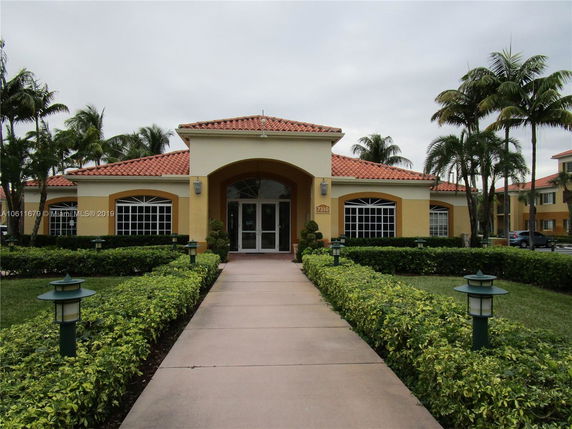 Front view of a building with a tiled roof and arched entrance.