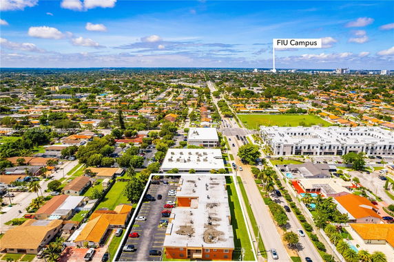 Aerial view of an urban area with a mix of residential and commercial buildings.