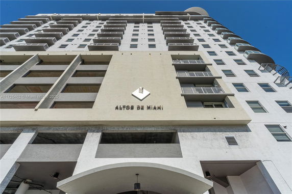 Front view of a multi-story building with balconies.